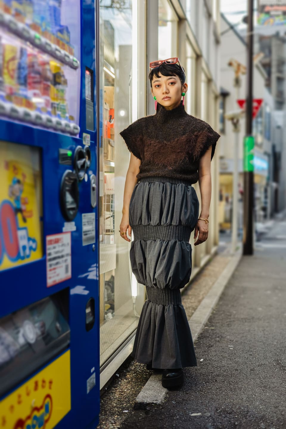 Tokyo avant-garde: Stylish woman in Tokyo's urban landscape, wearing a chic skirt and sweater.